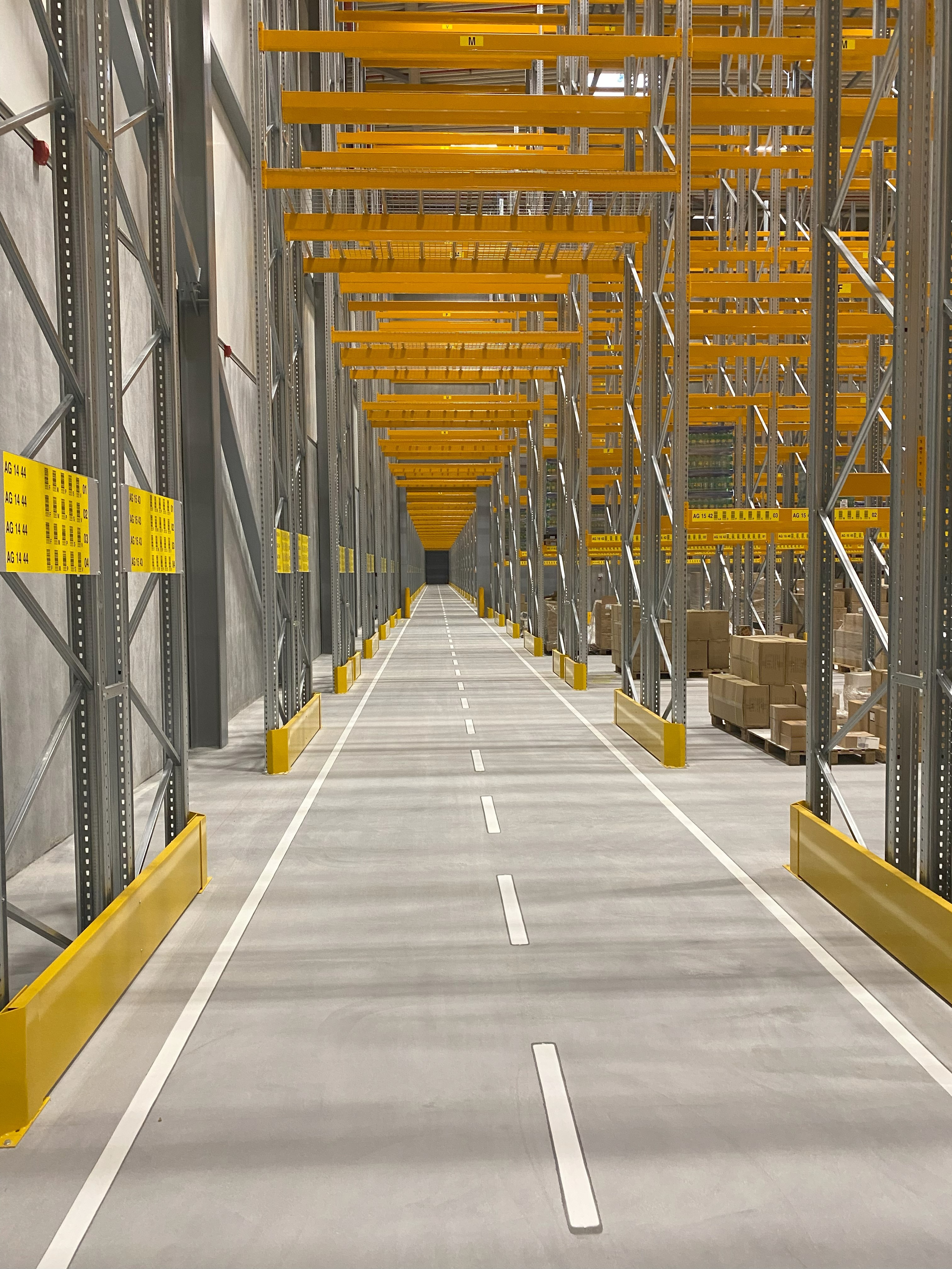 Finished joint-free flooring in warehouse. mezzanine, joint free roller compacted concrete floors 