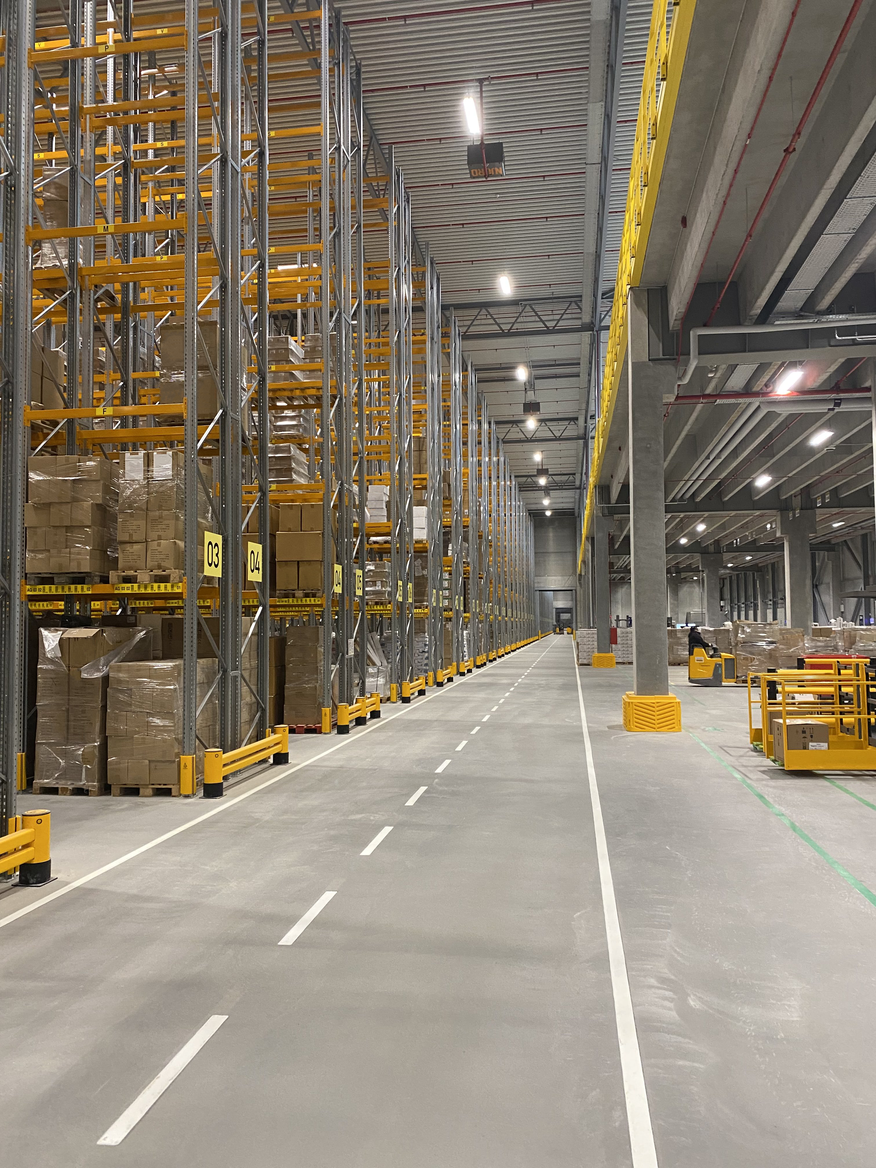 Finished joint-free flooring in warehouse. mezzanine, joint free roller compacted concrete floors 