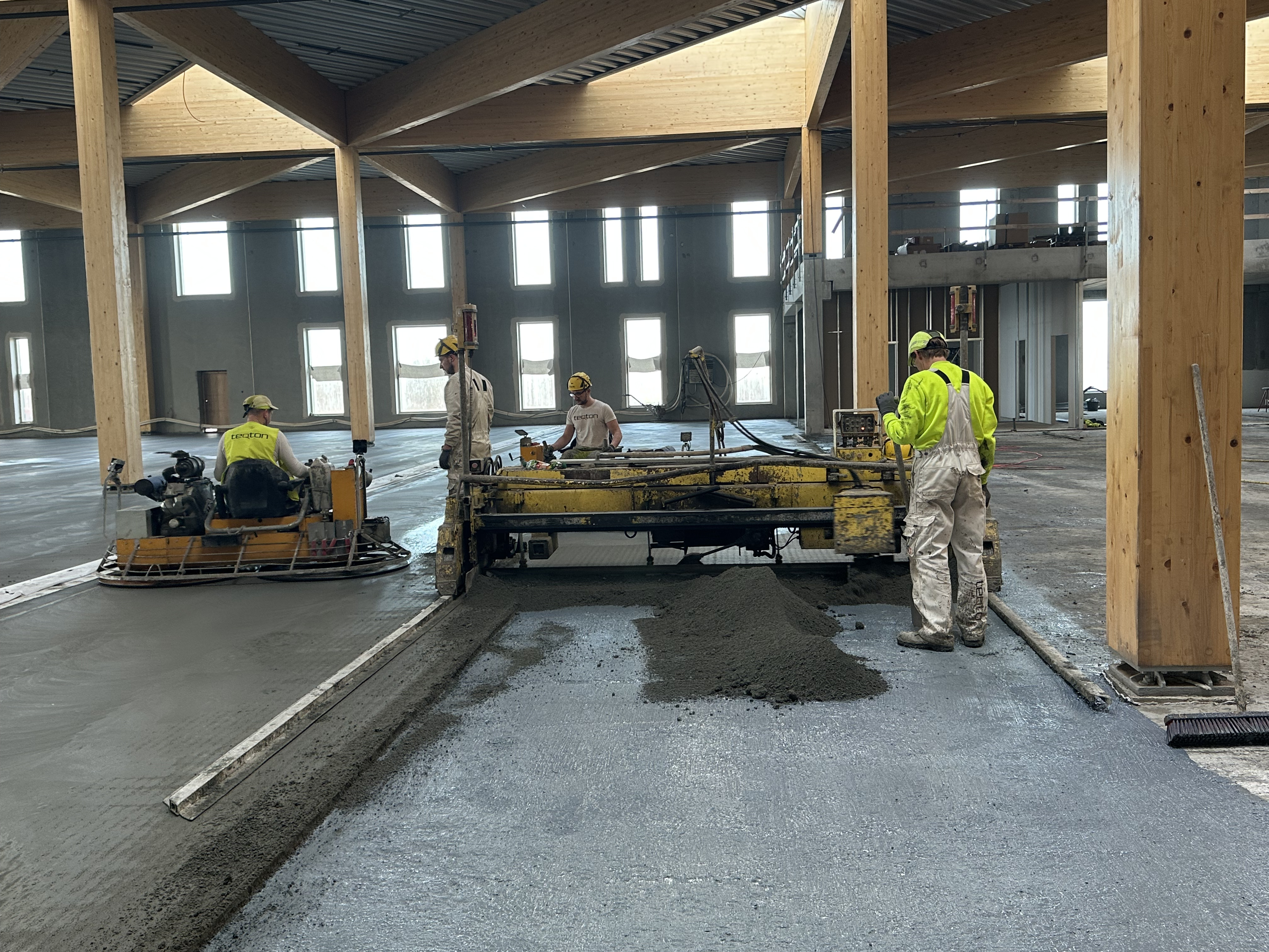 New ware house flooring with teqbase sublayer and teqplan wear layer. Teqbase layer being layed out
