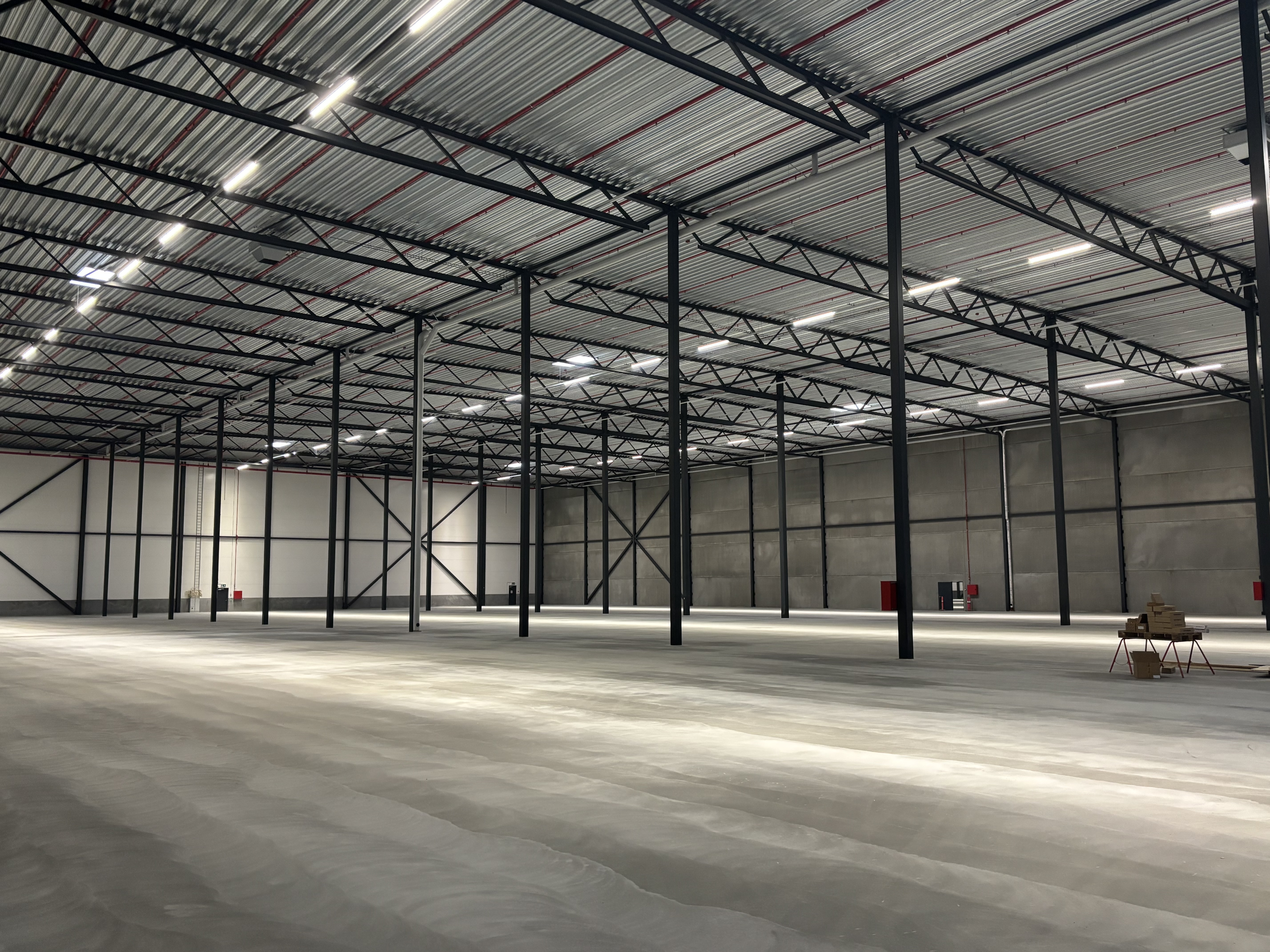 Finished concrete flooring in warehouse facilities. base and wear layer. high-bay warehouse. Narrow aisle warehouse. 